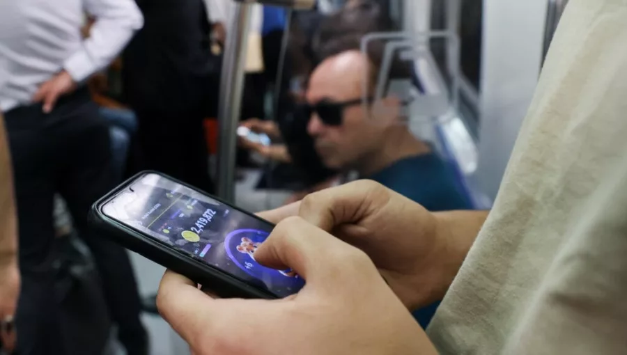 An Iranian playing Hamster Combat, a Telegram crypto game, according to IRNA